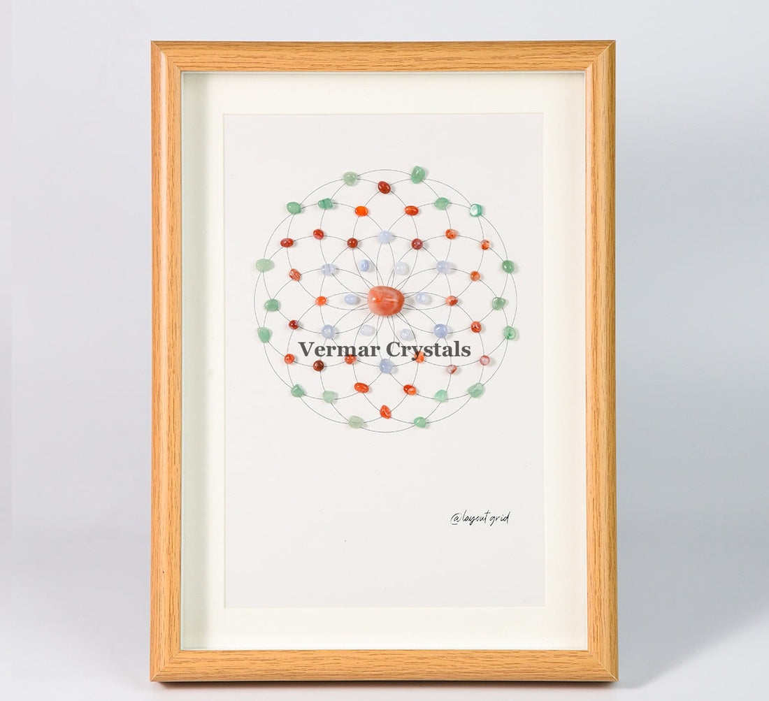 Health & Healing crystal grid art with green aventurine, red and blue agate stones in wooden frame on gray background