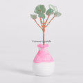 Small green aventurine crystal tree ornament with twisted wire branches in a pink and white ceramic vase