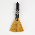 Handcrafted ritual witch broom with natural straw, black crystal handle, compass charm, and tiger's eye stone on white background