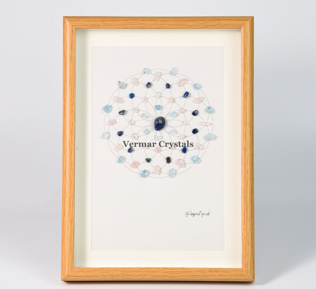 Stress Relief and Relaxation crystal grid painting framed with Lapis Lazuli, Aquamarine, and soft pastel stones on white background