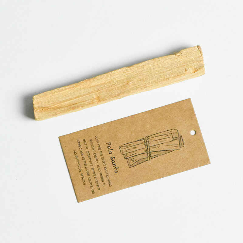 Natural Palo Santo stick 10cm with brown kraft paper label featuring hand-drawn bundle illustration on white surface