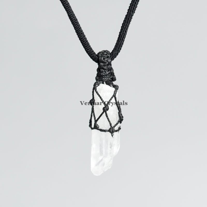 Clear quartz point pendant wrapped in black hand-woven cord on simple black necklace against light background