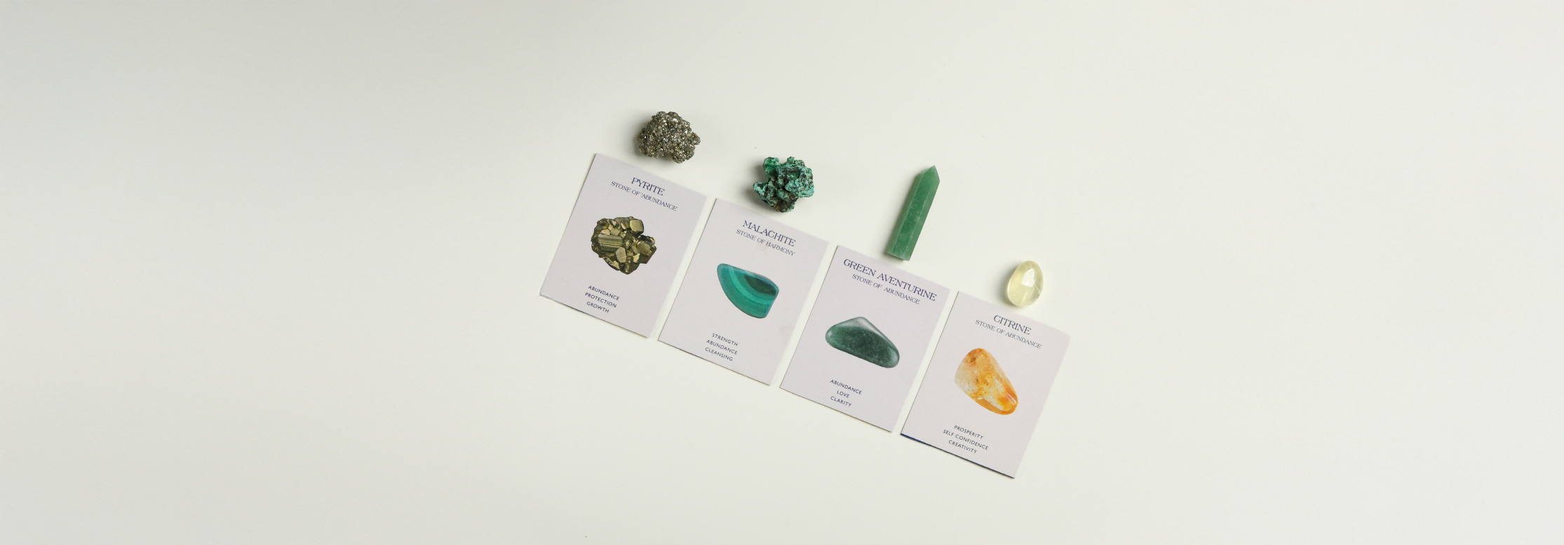 Wealth and Abundance crystal set with pyrite, malachite, green aventurine, and citrine stones on white cardsslider_item_f44eqh