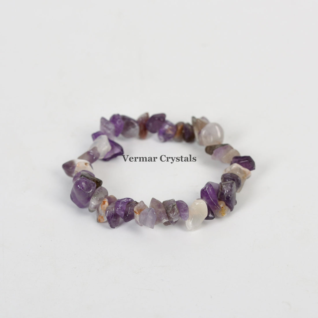 Handmade stretchy bracelet with irregular polished amethyst chip stones in various purple shades on white background