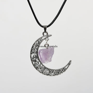 Handcrafted amethyst raw crystal pendant hanging inside a filigree silver crescent moon on a black cord necklace