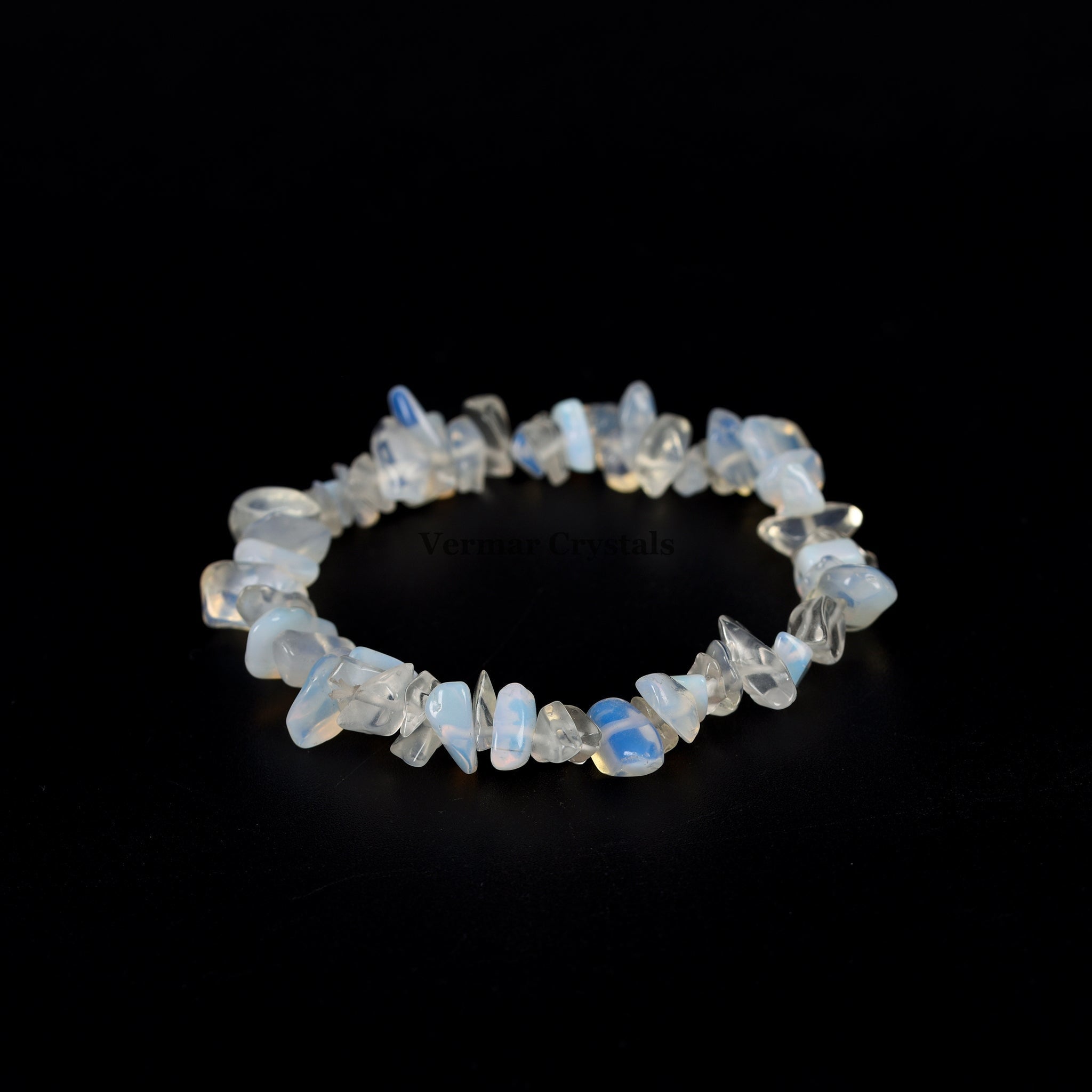 Handmade stretch bracelet featuring irregular polished opal chip stones with soft blue and white hues on a black background