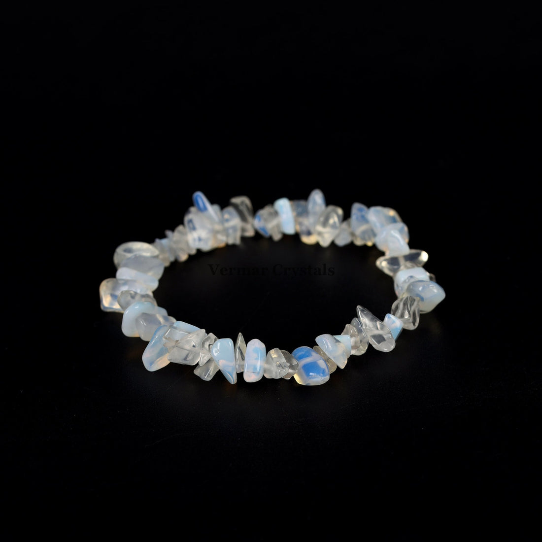 Handmade stretch bracelet featuring irregular polished opal chip stones with soft blue and white hues on a black background