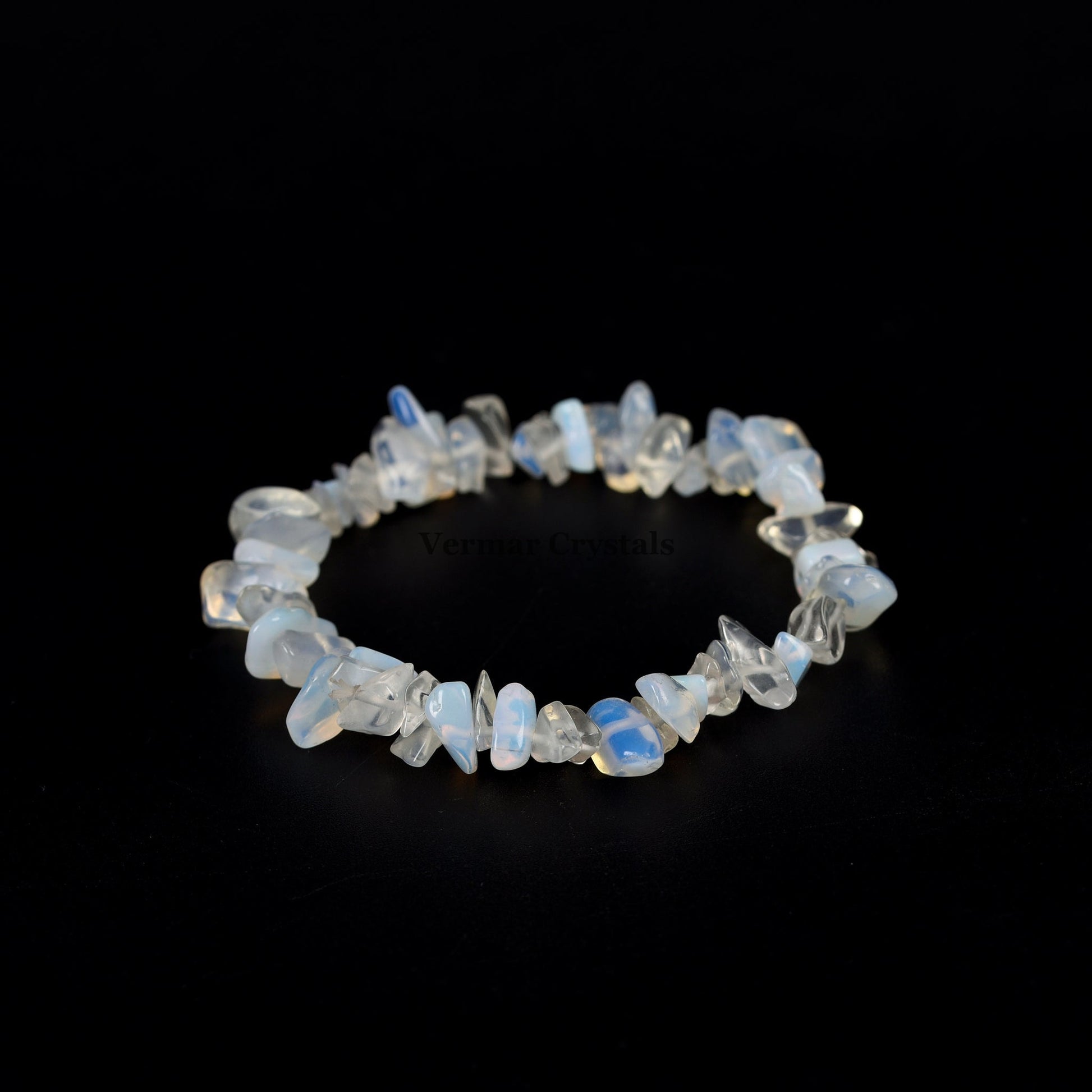 Handmade stretch bracelet featuring irregular polished opal chip stones with soft blue and white hues on a black background