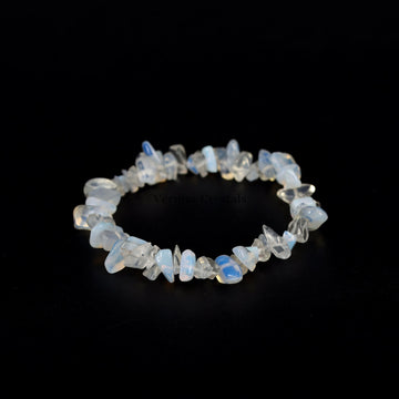 Handmade stretch bracelet featuring irregular polished opal chip stones with soft blue and white hues on a black background