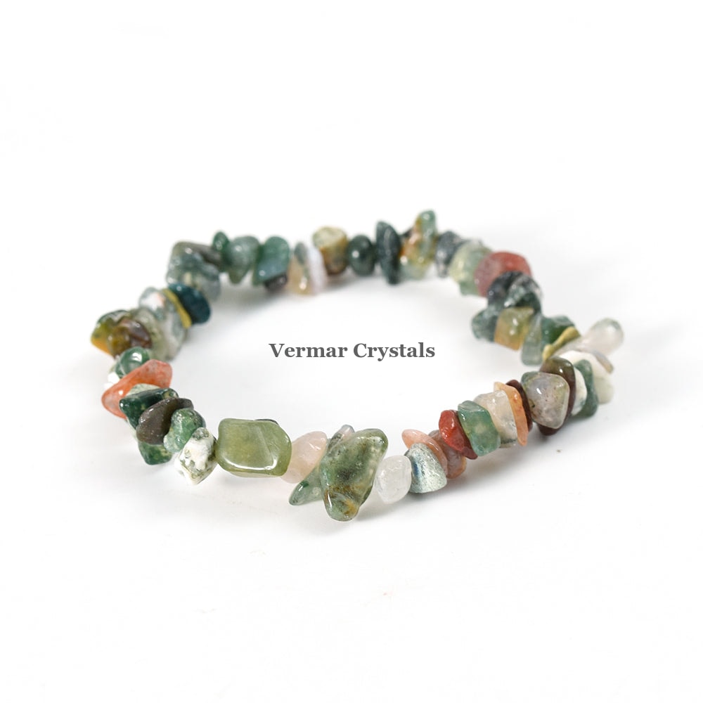 Handmade stretchy bracelet made of polished multicolored moss agate chip stones arranged in a circle on white background