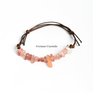 Handmade bracelet with irregular pink strawberry quartz chips on adjustable brown leather cord on white background