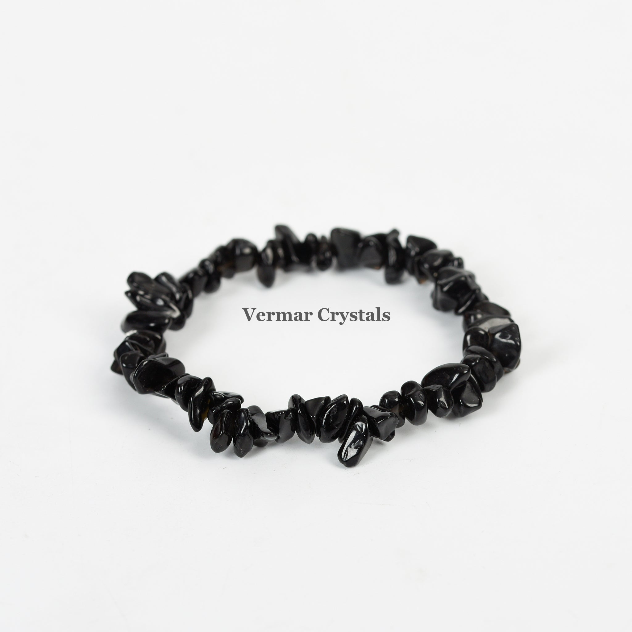Stretchy handmade bracelet made of polished irregular black agate chip stones on a white background
