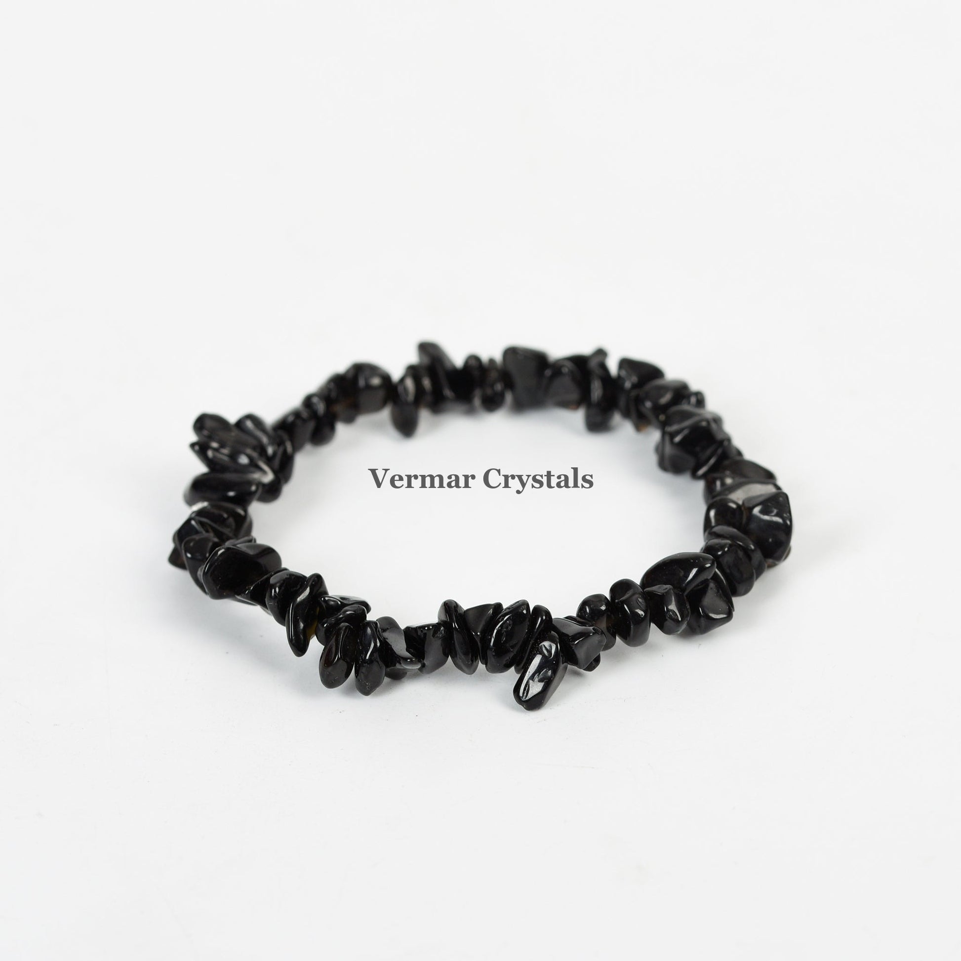 Stretchy handmade bracelet made of polished irregular black agate chip stones on a white background