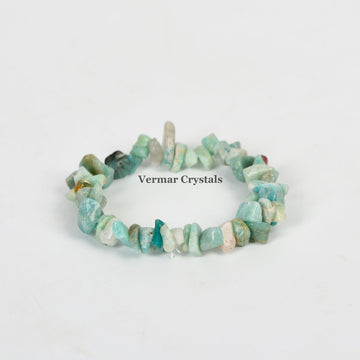 Handmade stretchy bracelet made of irregular light blue and green amazonite chip stones on a white background