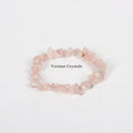 Handmade stretchy bracelet made of irregular pale pink rose quartz chip beads on a white background