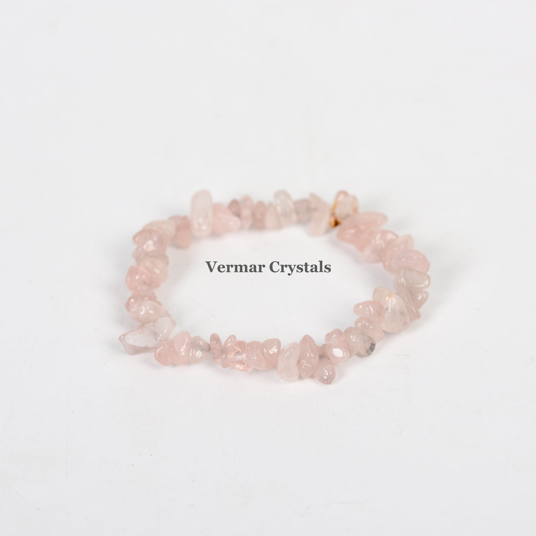 Handmade stretchy bracelet made of irregular pale pink rose quartz chip beads on a white background